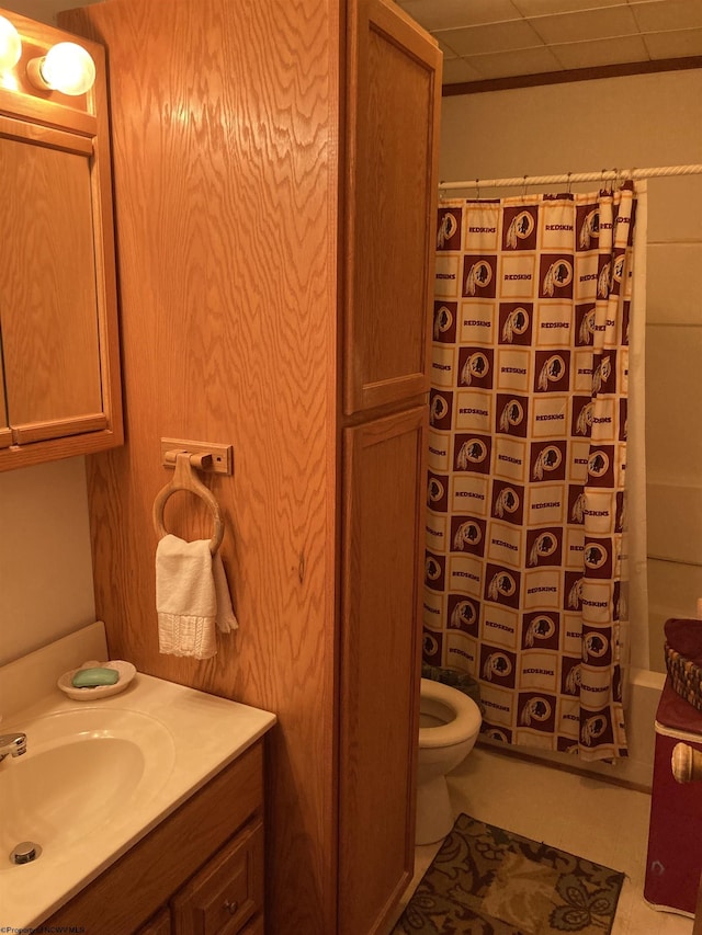 bathroom with vanity, curtained shower, tile patterned floors, and toilet