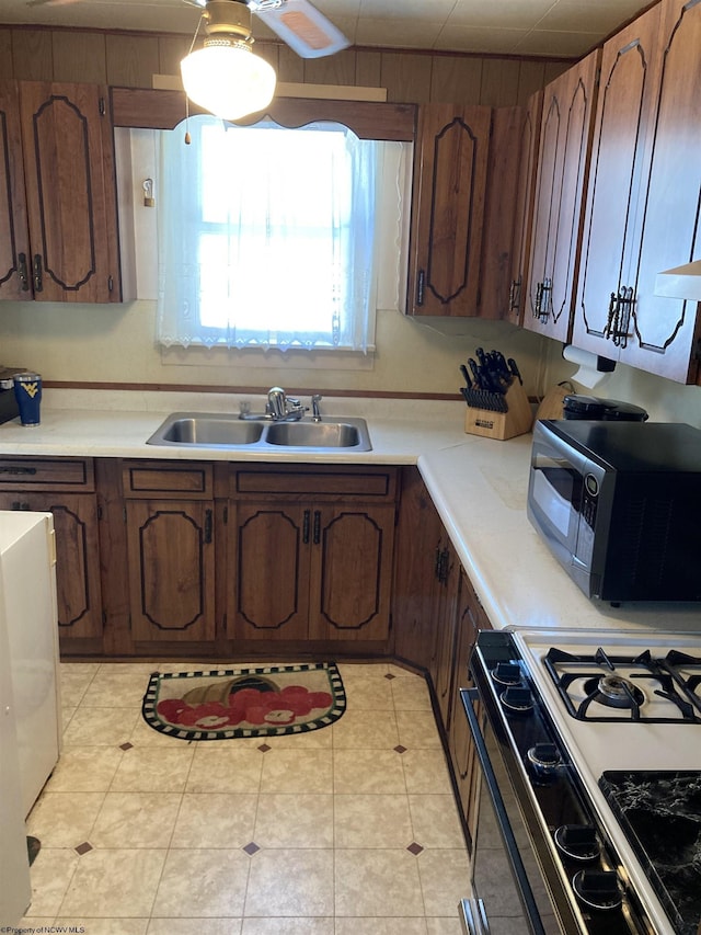 kitchen featuring gas stove and sink