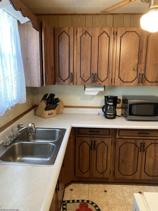 kitchen featuring sink and light tile patterned floors