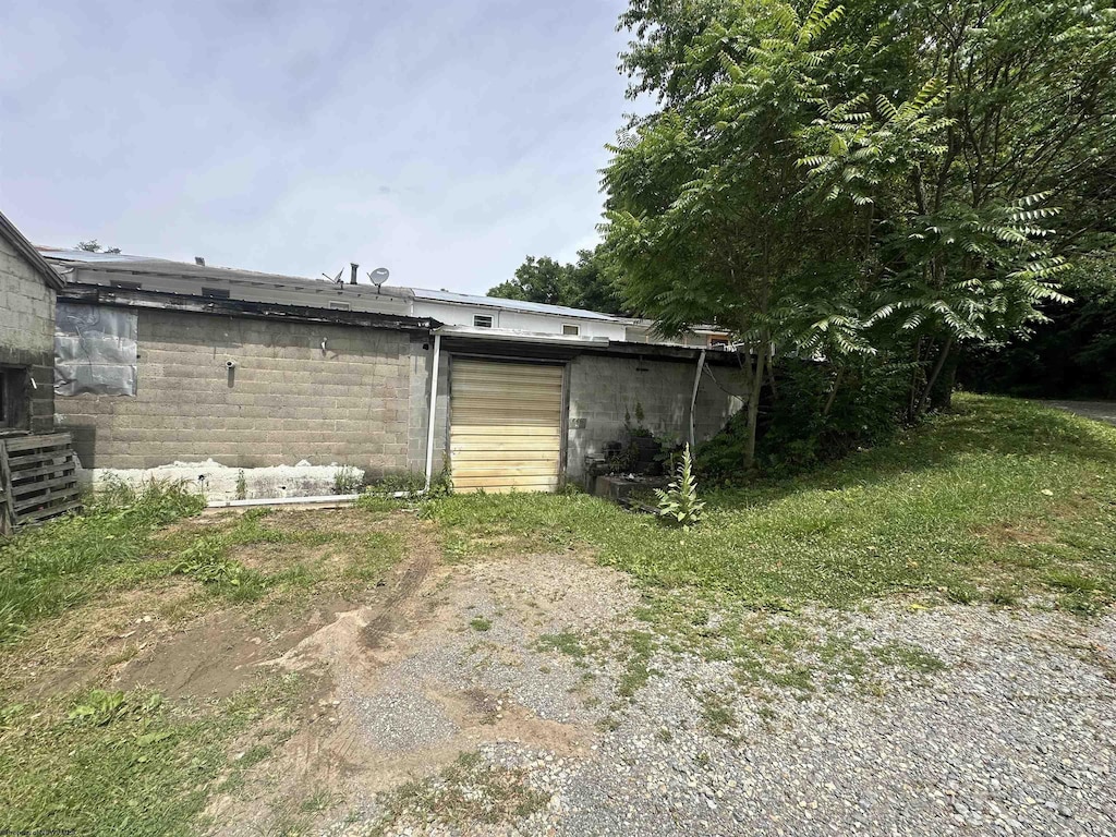 back of house with concrete block siding