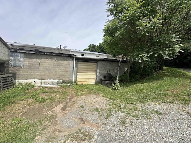 back of house with concrete block siding