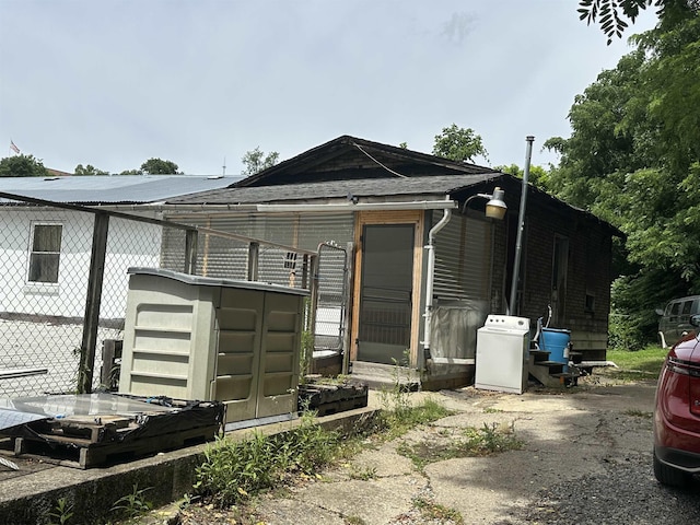 exterior space featuring washer / dryer and fence