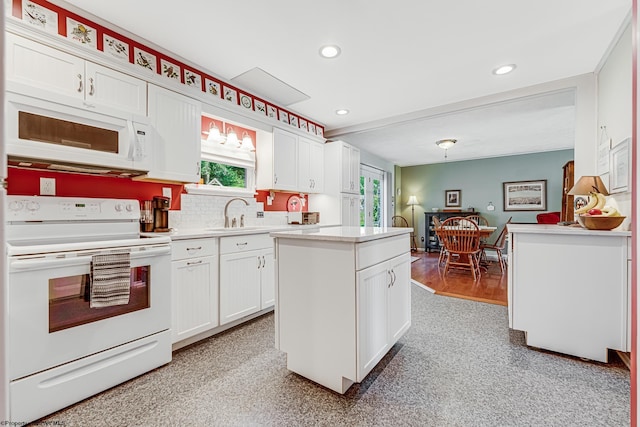 kitchen with white cabinetry, white appliances, and plenty of natural light