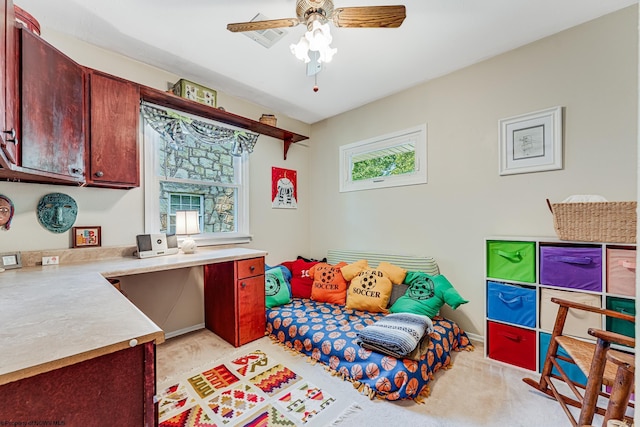 carpeted bedroom with ceiling fan and multiple windows