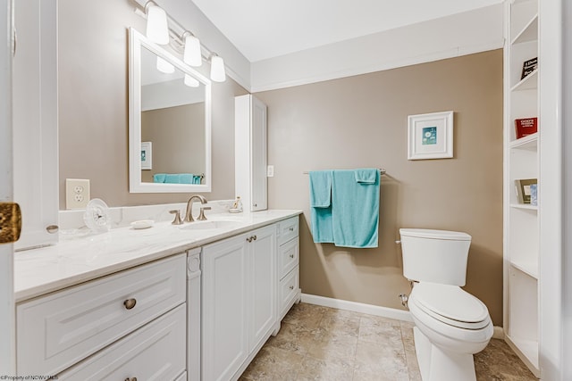 bathroom featuring tile flooring, vanity, and toilet