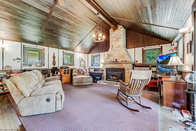 living room featuring a stone fireplace, a chandelier, hardwood / wood-style flooring, and wood ceiling