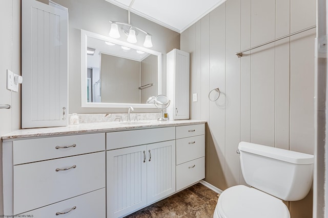 bathroom featuring tile floors, ornamental molding, toilet, and vanity