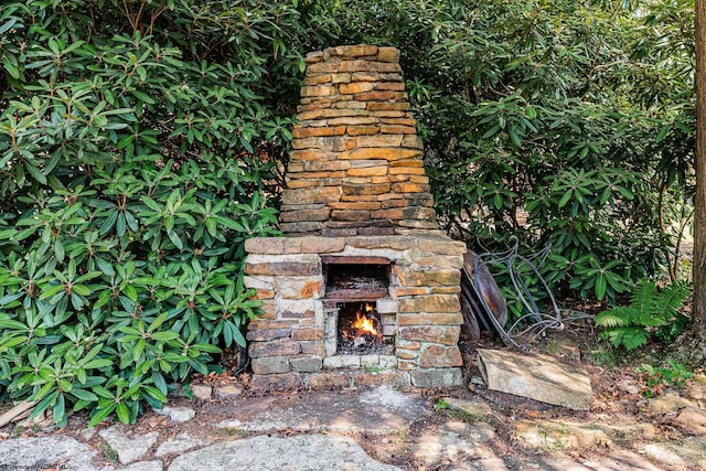 exterior details with an outdoor stone fireplace