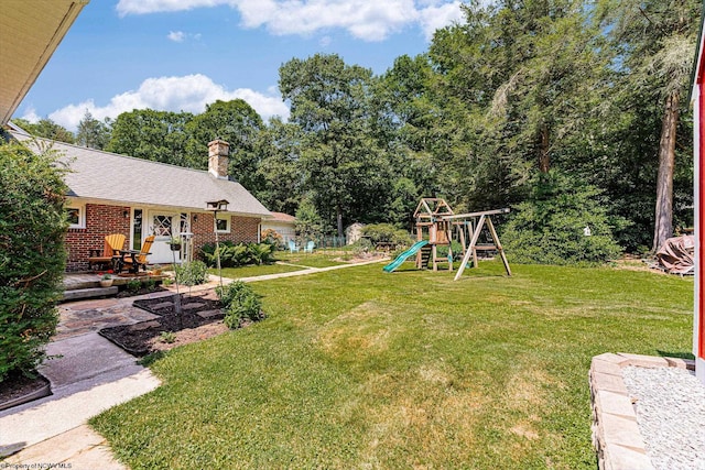 view of yard featuring a playground and a wooden deck