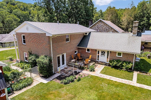 back of property with a yard, french doors, and a patio