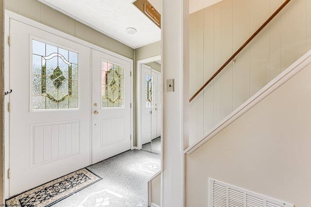 view of carpeted foyer entrance