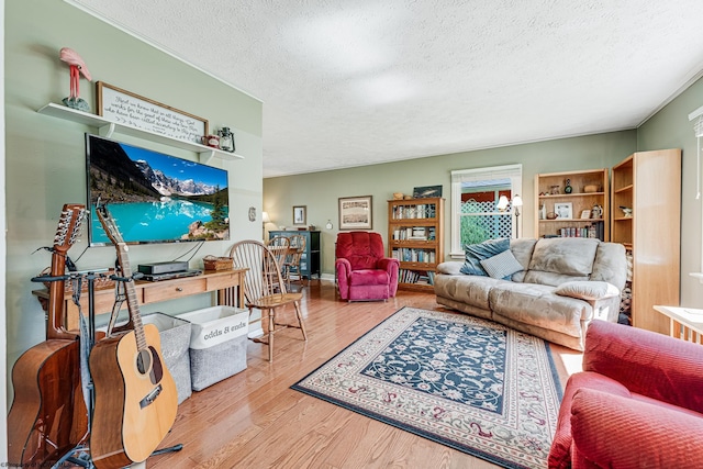 living room featuring an inviting chandelier, a textured ceiling, and wood-type flooring