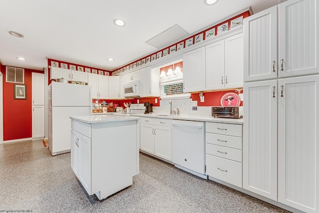 kitchen featuring a center island, white appliances, white cabinets, sink, and tasteful backsplash