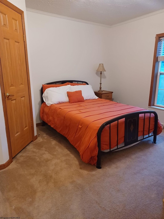 bedroom featuring carpet flooring and crown molding