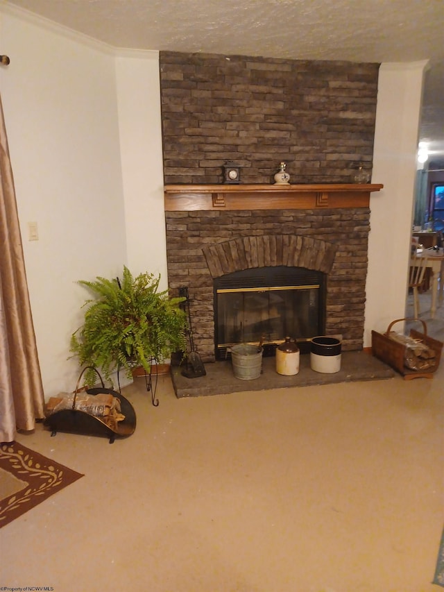 interior details featuring a stone fireplace, ornamental molding, and a textured ceiling