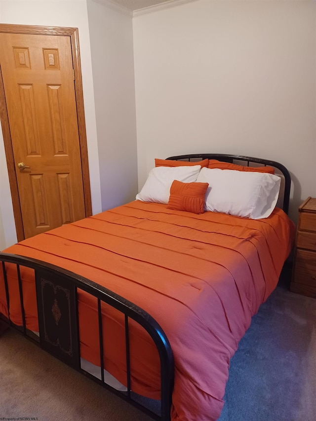 bedroom with dark colored carpet and crown molding