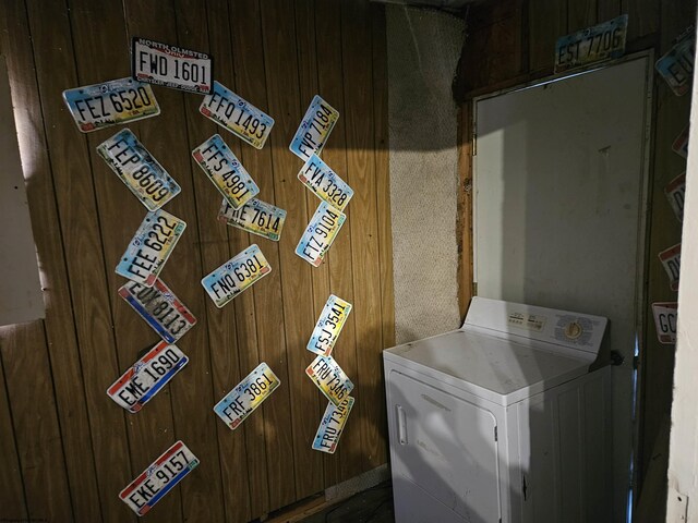 laundry area featuring washer / clothes dryer and wooden walls