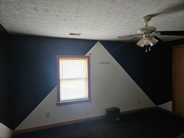 bonus room with carpet flooring, a textured ceiling, and ceiling fan