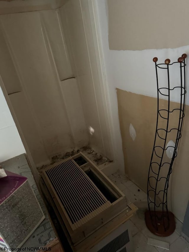 stairway with tile patterned floors