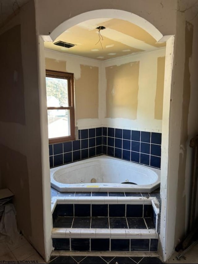 bathroom featuring tiled bath