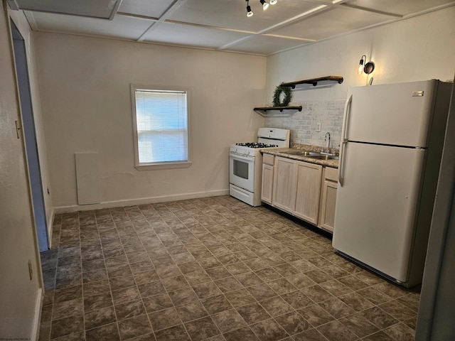 kitchen featuring backsplash, sink, white appliances, and dark tile patterned flooring