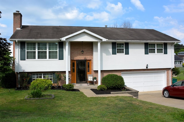 split foyer home with a garage and a front yard