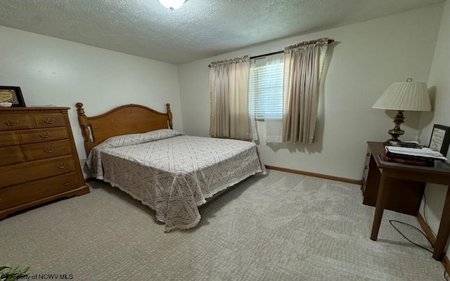 carpeted bedroom featuring a textured ceiling