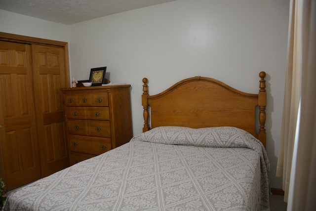 bedroom with a closet and a textured ceiling