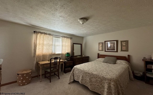 bedroom with carpet flooring and a textured ceiling