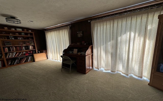 home office with carpet floors and a textured ceiling