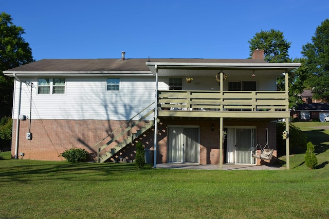 back of property featuring a patio area and a lawn