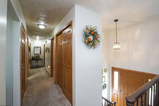 entrance foyer featuring carpet flooring and a textured ceiling