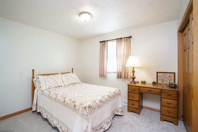 carpeted bedroom featuring a textured ceiling and a closet