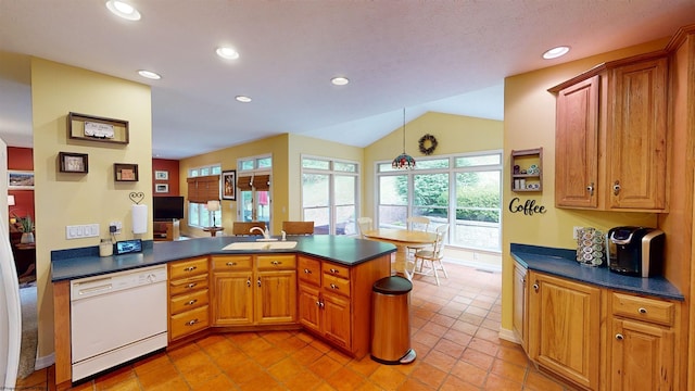 kitchen with kitchen peninsula, white dishwasher, sink, light tile patterned floors, and lofted ceiling