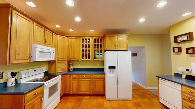 kitchen featuring white appliances and light tile patterned flooring