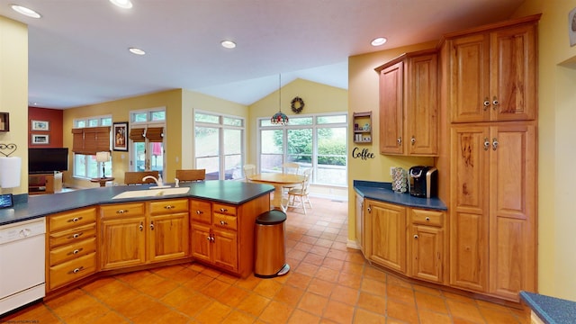 kitchen with dishwasher, sink, kitchen peninsula, vaulted ceiling, and light tile patterned flooring