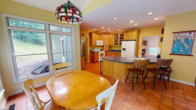 dining room featuring plenty of natural light, light tile patterned floors, and sink