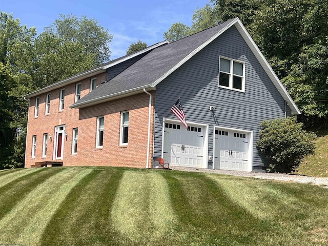 view of side of property featuring a lawn and a garage