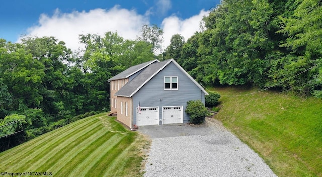 exterior space with a garage and a yard