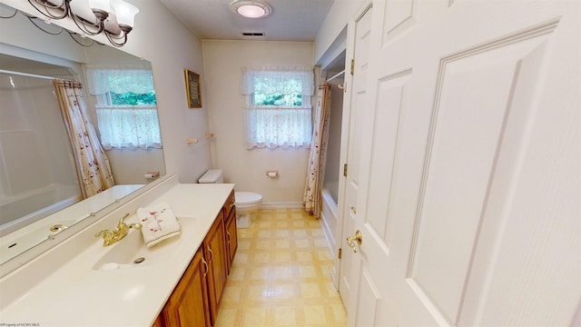 full bathroom featuring vanity, toilet, and shower / tub combo