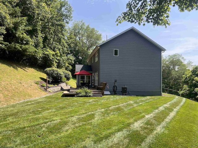 rear view of property featuring a yard and a wooden deck