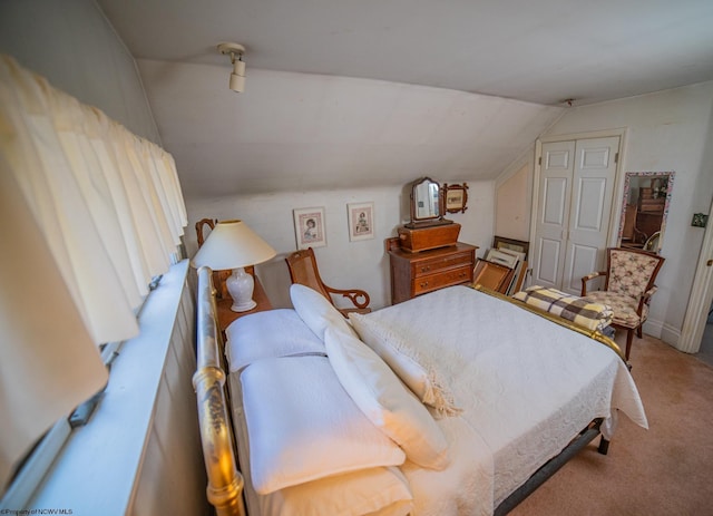 carpeted bedroom featuring vaulted ceiling