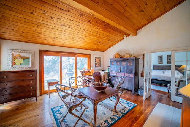 dining room with lofted ceiling with beams, wooden ceiling, and dark hardwood / wood-style flooring