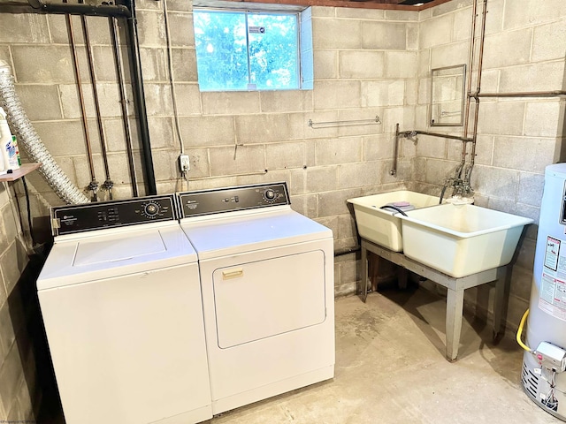 washroom featuring water heater and independent washer and dryer