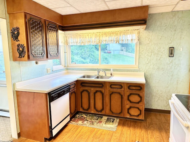 kitchen featuring light wood-type flooring, white appliances, and sink