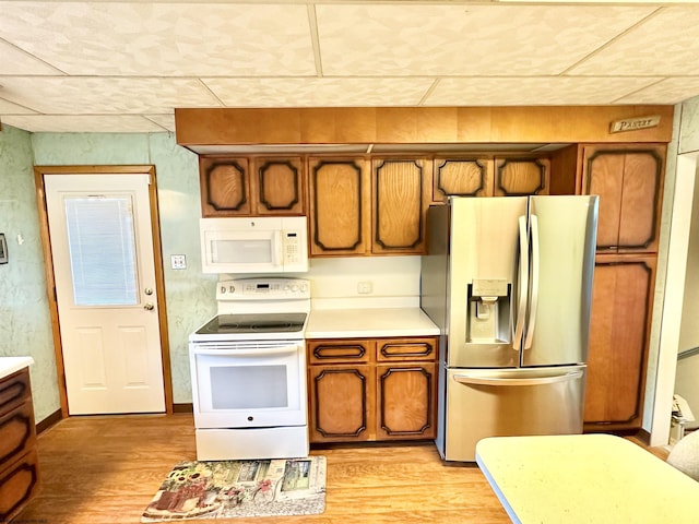 kitchen featuring light hardwood / wood-style flooring and white appliances