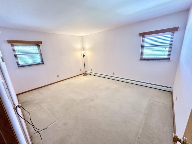 unfurnished room featuring light carpet and baseboard heating