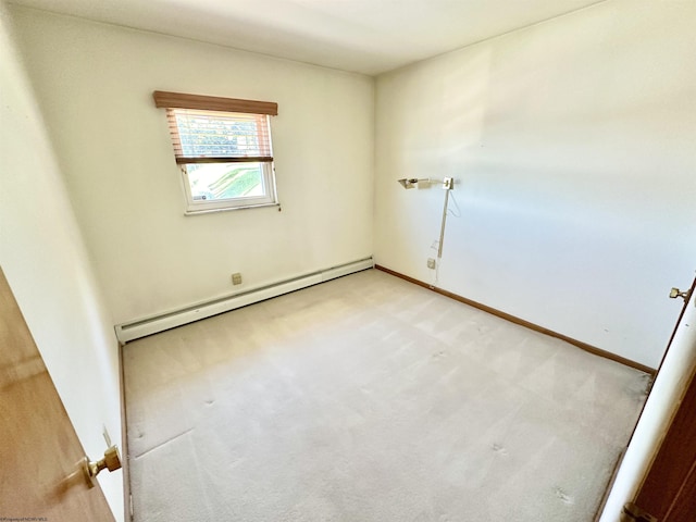 carpeted spare room featuring baseboard heating