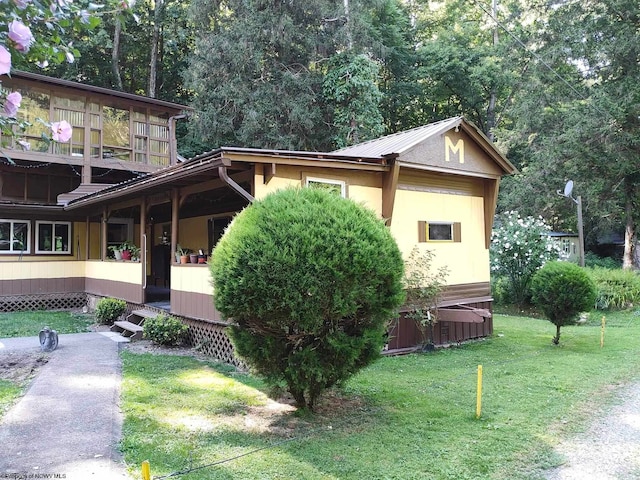 view of side of home featuring a lawn