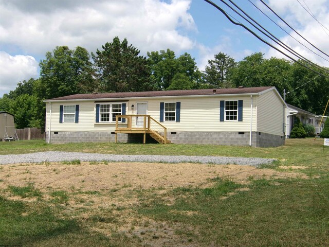 manufactured / mobile home featuring crawl space, a front yard, and fence